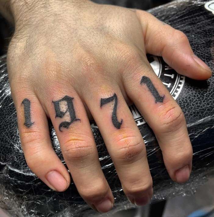 1971 tattoo on finger