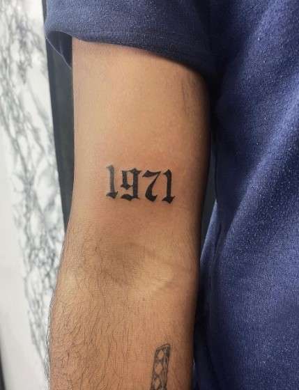 1971 tattoo on right arm