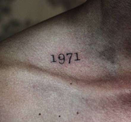 1971 tattoo on shoulder