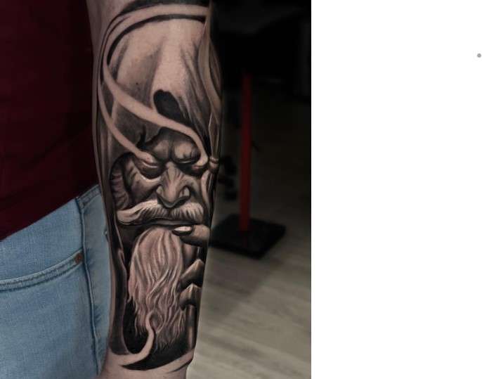 Hades tattoo on left arm