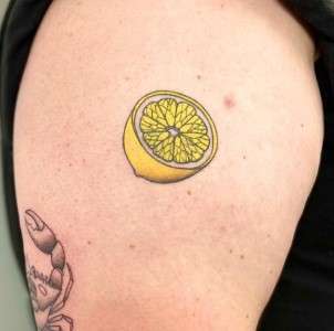 lemon tattoo on thigh design