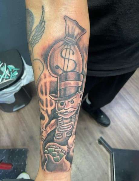  Monopoly Man tattoo symbol on forearm