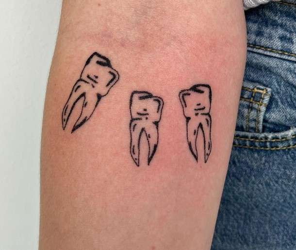 Boygenius Tooth Tattoo on arm