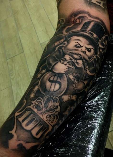 Gangster monopoly man tattoo on forearm