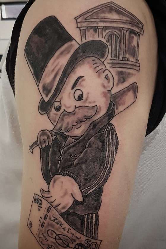 Gangster monopoly man tattoo on arm