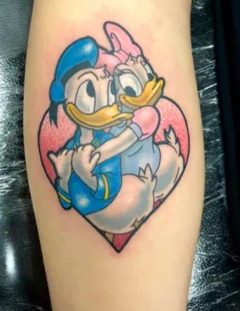 Donald duck tattoo with daisy