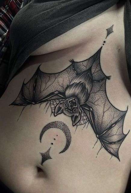 Feminine Bat tattoo on upper belly