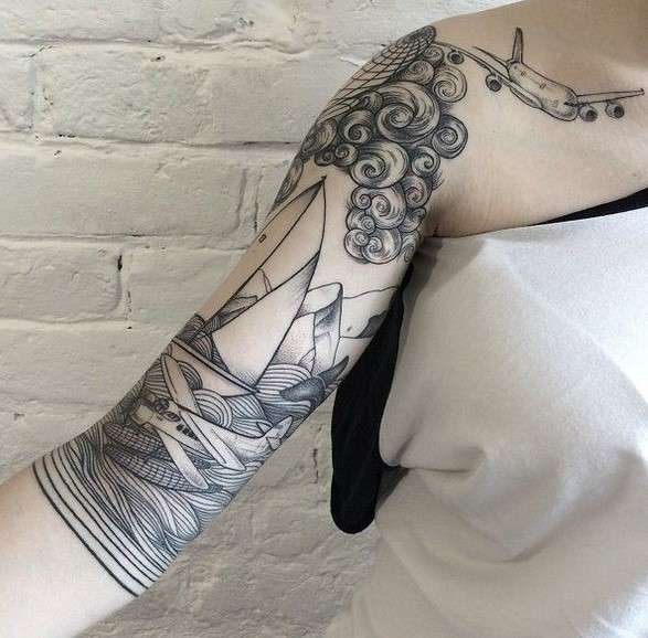 Whimsical tattoo sleeve sea and plane