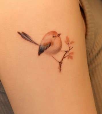 Whimsical small bird tattoo