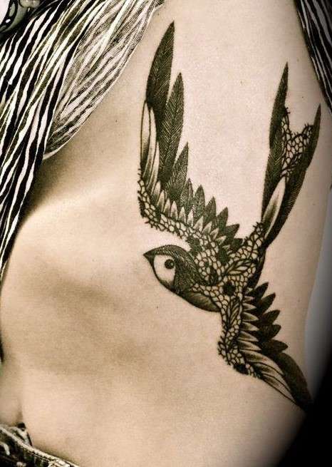 Whimsical bird tattoo dark