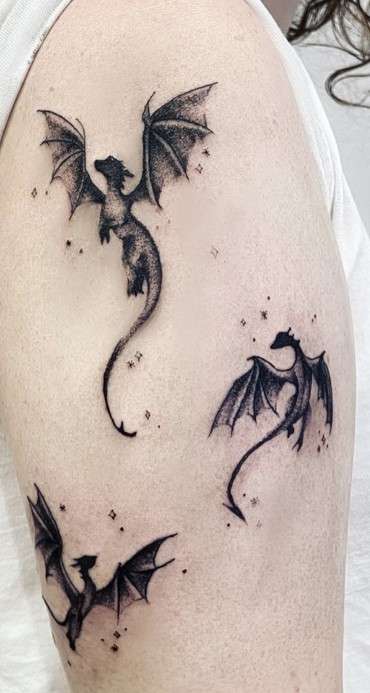 Whimsical three playful Dragon tattoo