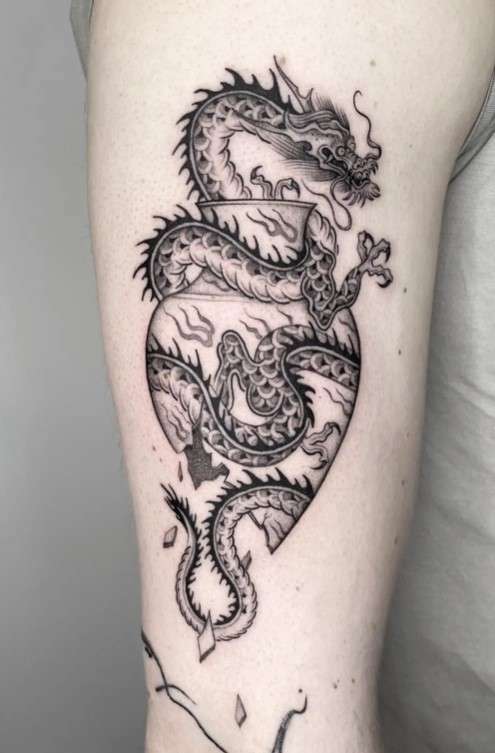 Whimsical Dragon tattoo with vase