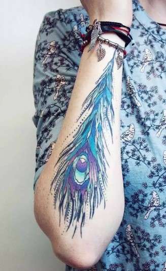 Whimsical feather tattoo charming