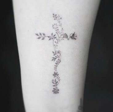 Whimsical shade Cross tattoo