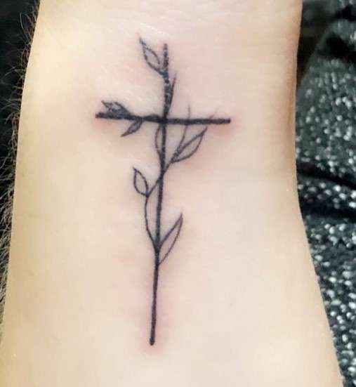 minimalistic Whimsical Cross tattoo