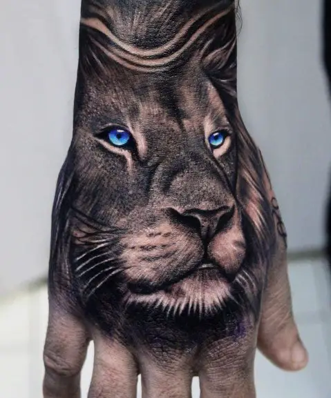 Lion with Blue eyes tattoo on hand