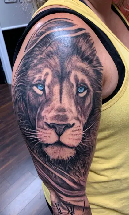 Lion with Blue eyes tattoo on arm