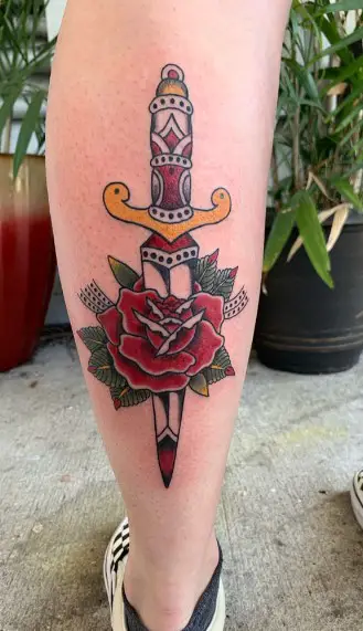 Dagger And Rose tattoo on leg